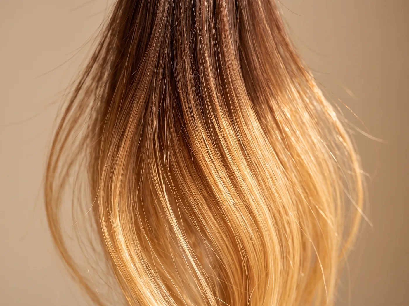 Close-up of hand-painted balayage color gradient on hair strands